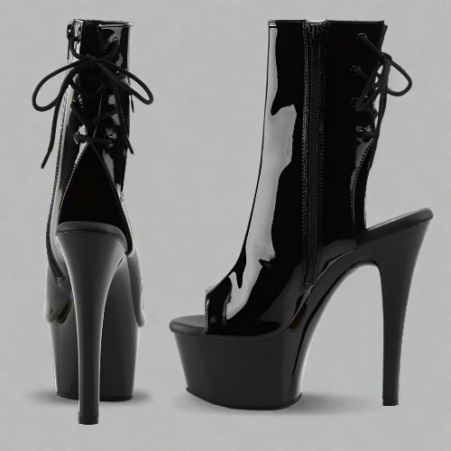Black high-heeled platform boots on a white background