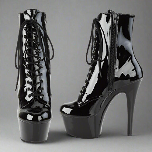 Black patent leather high-heeled boots on a white background