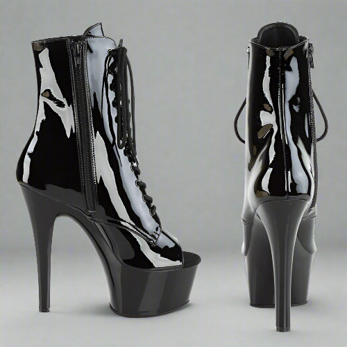 Black high-heeled platform boots on a white background