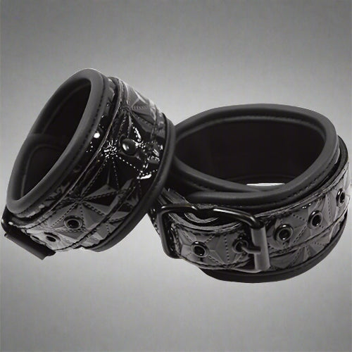 Black metal ring with intricate design on a white background