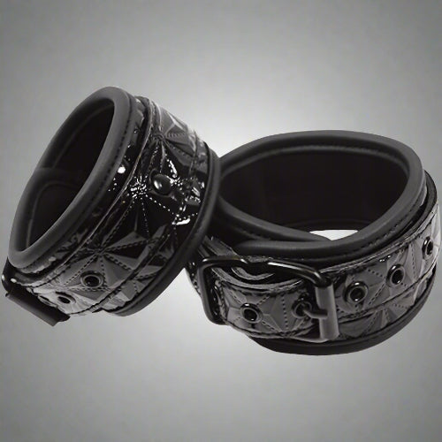Black metal ring with intricate design on a white background
