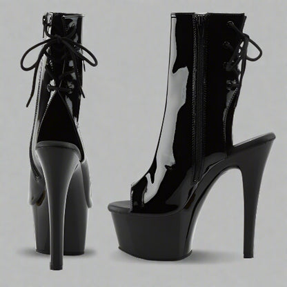 Black high-heeled platform boots on a white background