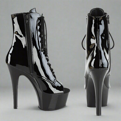Black high-heeled platform boots on a white background