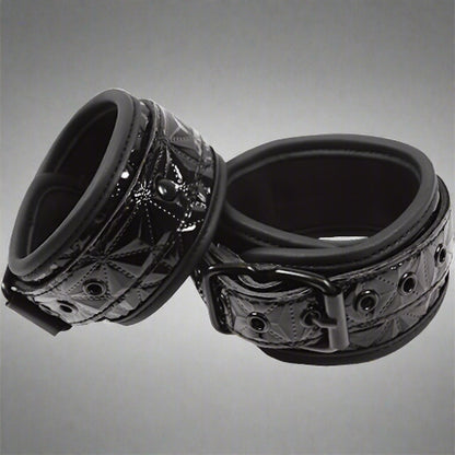 Black metal ring with intricate design on a white background